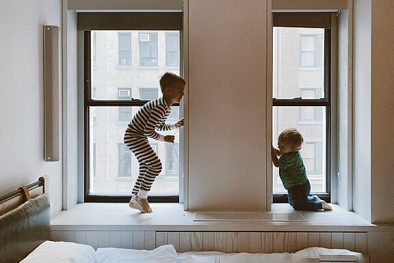 two-kids-playing-beside-glass-windows-3273851.jpg 